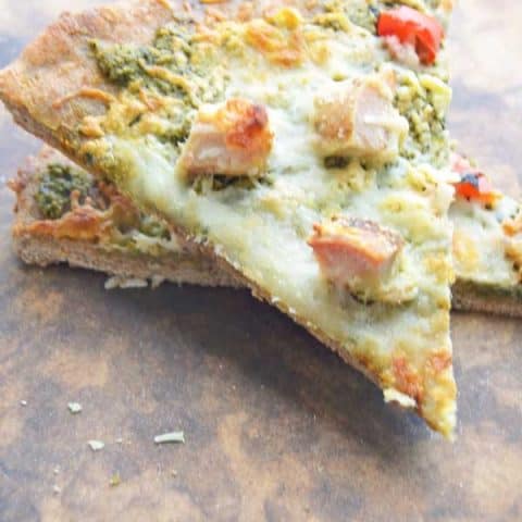 Chicken Pesto Pizza with garlic and roasted red peppers. Delish!