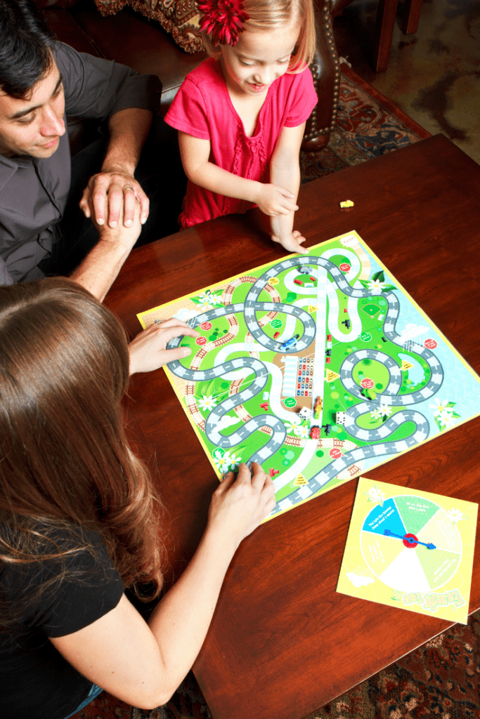 family blays board game together at the table