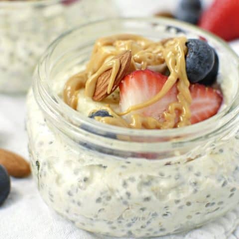 Delicious breakfast of overnight oats with Greek yogurt, peanut butter drizzle and fresh berries