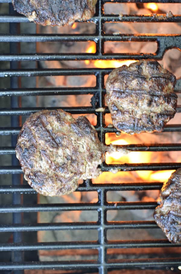Burgers on grill with flames