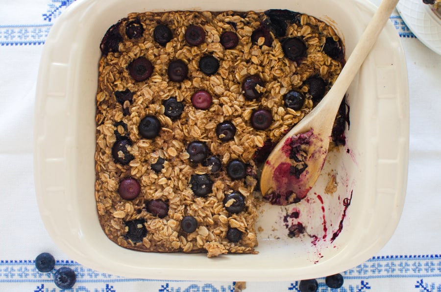 Pan of blueberry baked oatmeal with one piece taken out