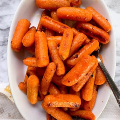 Honey roasted carrots in a white dish