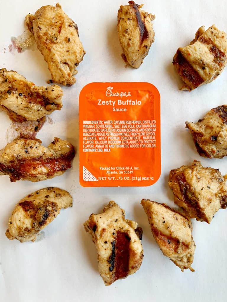 healthy chickfila grilled nuggets in circle around pack of zesty buffalo sauce