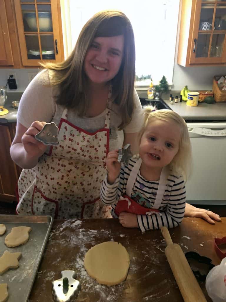 mom and sweet toddler baking christmas cookies
