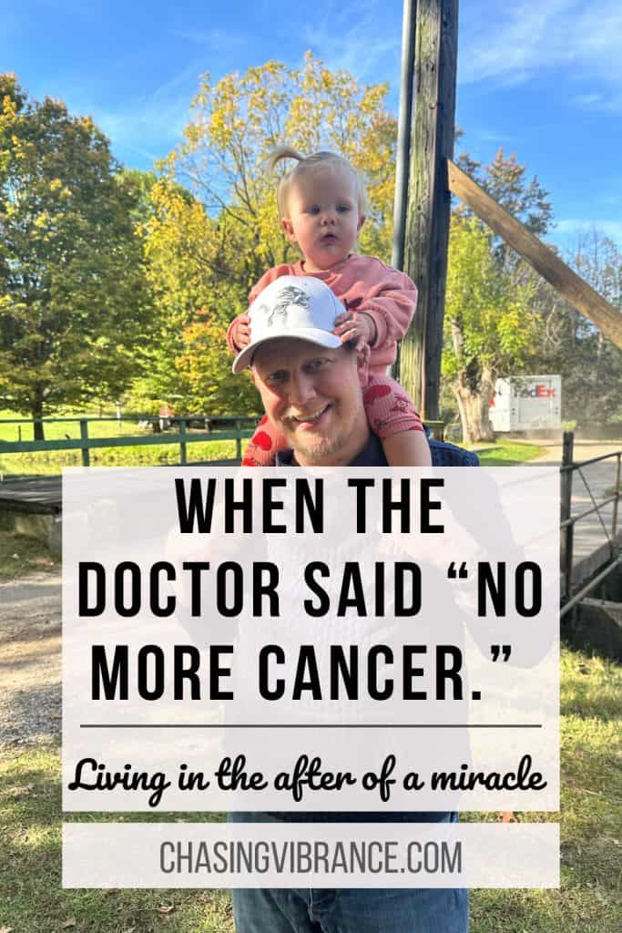 Picture of a man holding a baby girl on his shoulders with a ball cap on his head in the autumn sunshine. Text reads: when the doctor said "no more cancer" living in the after of a miracle.