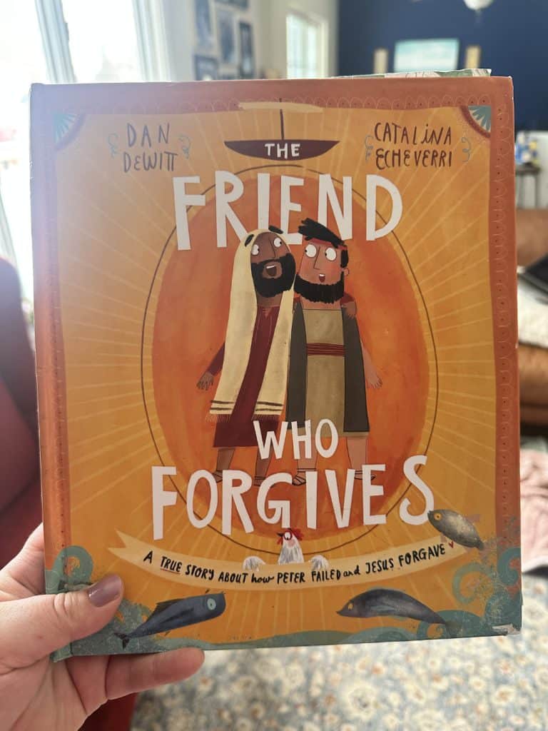 the friend who forgives an orange kids Easter book about Jesus and Peter held aloft in a bright living room