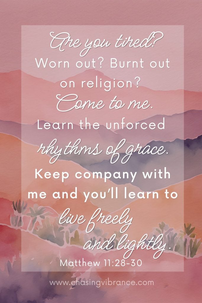 Matthew 11:28-30 in the message translation on a pink toned watercolor of the desert with white words