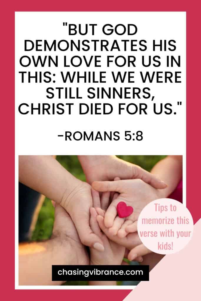 Romans 5:8 text of Bible verse on God's love in sans-serif font with photo of a family holding hands with a heart in the middle